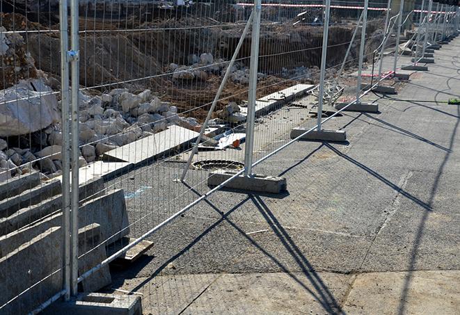 temporary fence panels being used as a visual barrier for a film or tv shoot location